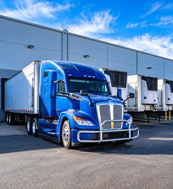 Row of refrigerated freight trailers at a loading dock